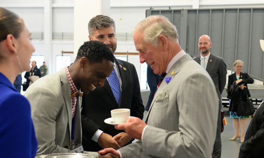 Daniel serving tea to King Charles III